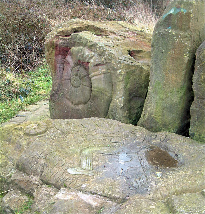 Stone Gateway -  to the left a boulder is carved with a snail