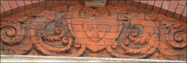 this panel shows a shield with stylised fish  decoration