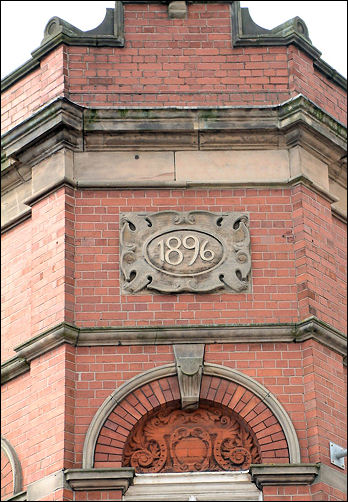 1896 date stone foliage and scrolls above entrance