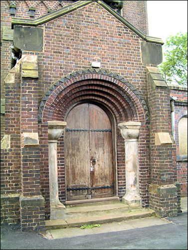 porch with round-arched stepped brick moulding to archway with chevron decoration