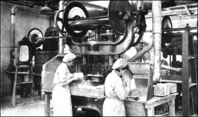 Tile making. All fettling dust is carried off by suction-draught hoods.