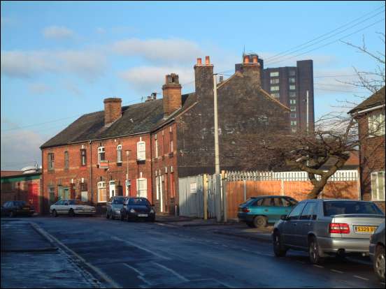 the advert is painted on the wall at the end of a terrace house in Raymond Street, Shelton