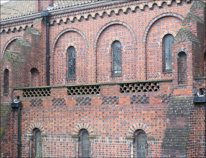 Italianate style, using the decorative properties of brick to enrich the facades with herringbone tiled courses etc.