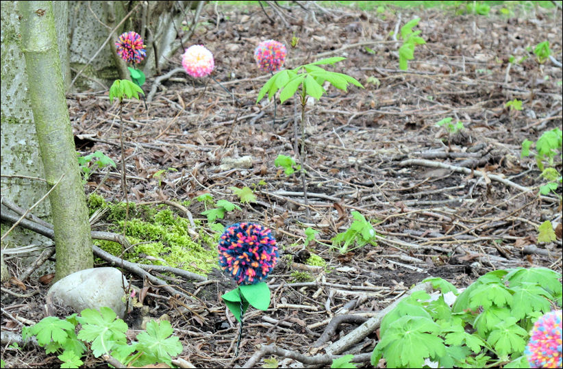 beyond the giant flowers are these small blooms - made by the public and set in the labyrinth area 