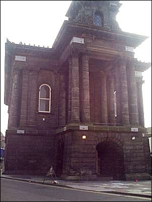 Directly in front of the alley is what was the Town Hall,