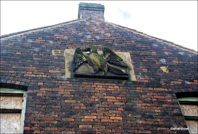 Stone plaque of falcon in gable apex