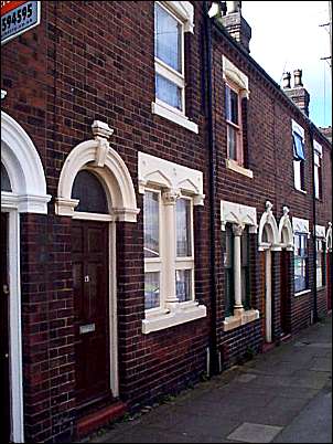 Less ornate houses from the opposite side of the road