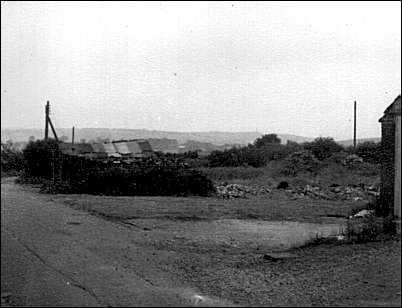 South westerly view down Heathside Lane from school buildings over disused allotments