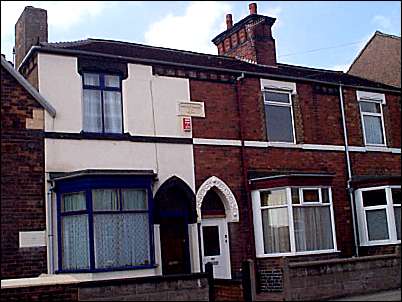 Row of terraced houses next to the church hall - the date reads 1874.