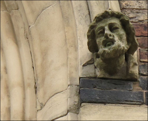 heads at the corners of the arch on the main door and windows 